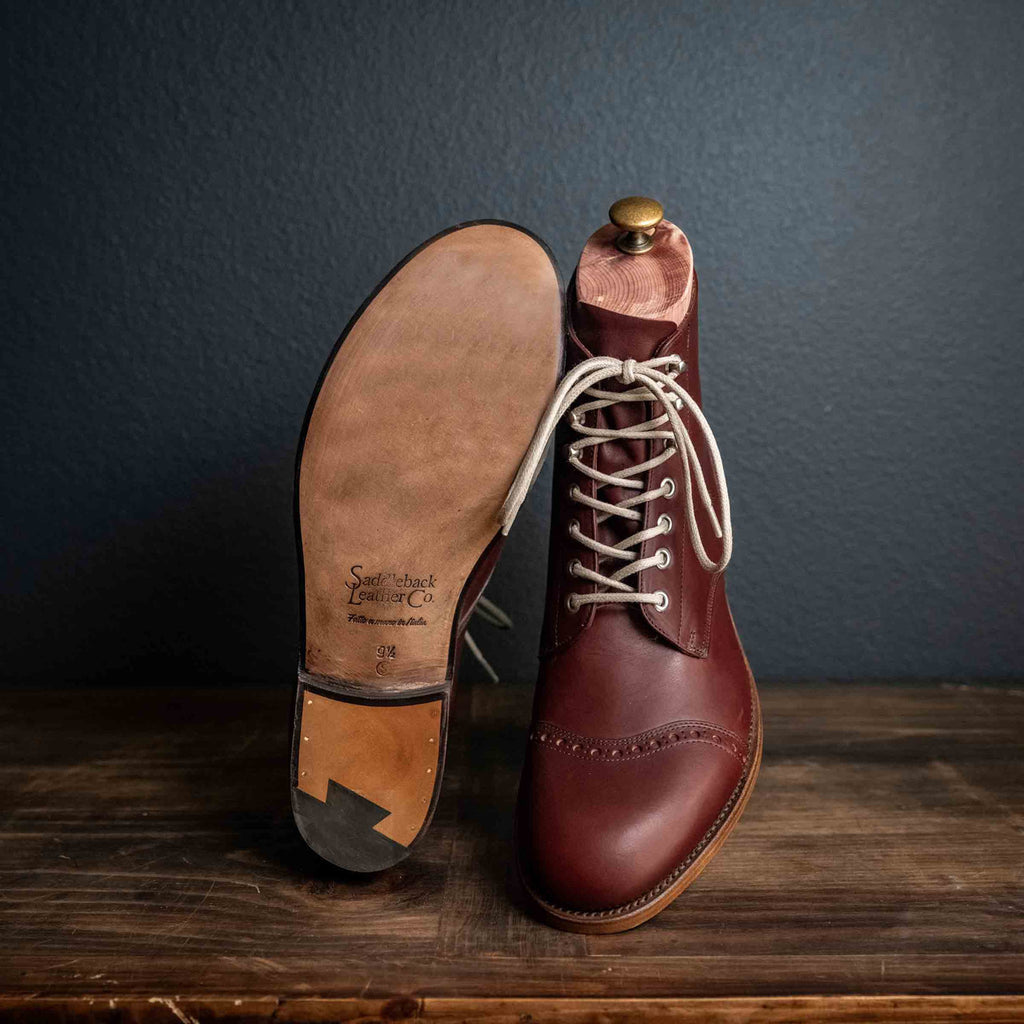 Officer Boot in Oxblood, one boot upright and one tilted to show the leather sole