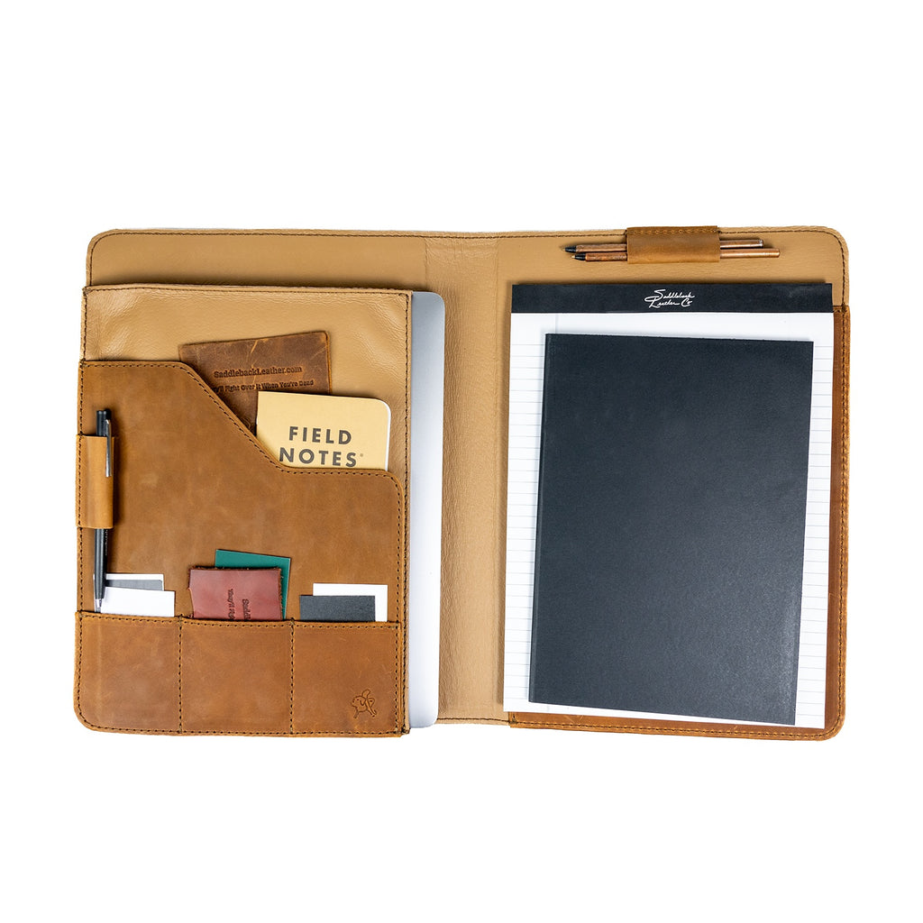 Large Leather Portfolio in Tobacco opened to show a notepad, tablet, pen, pocket notebook and cards in the pockets