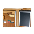 Large Leather Portfolio in Tobacco opened to show a notepad, tablet, pen, pocket notebook and cards in the pockets
