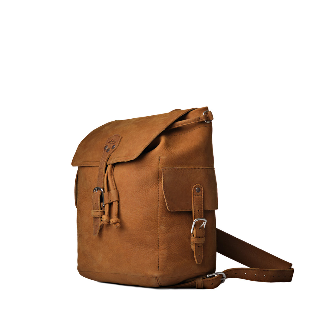 16" Drawstring Backpack in Tobacco, angled front view with buckled flap, side pocket and strap