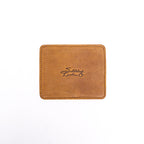 Leather Coaster Set in Tobacco, single square coaster with embossed Saddleback logo, top view