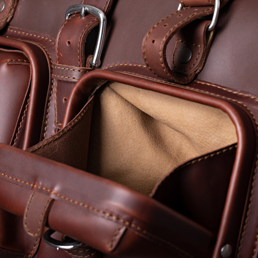 Deep Pocket Leather Duffle Bag in Chestnut, close-up of an open front pocket with suede lining and buckles