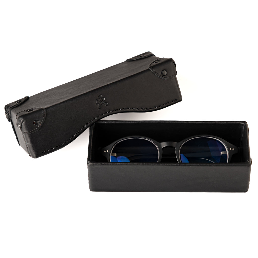 Grandfather Eyeglass Case in Black leather, open with a pair of round eyeglasses inside and lid beside it