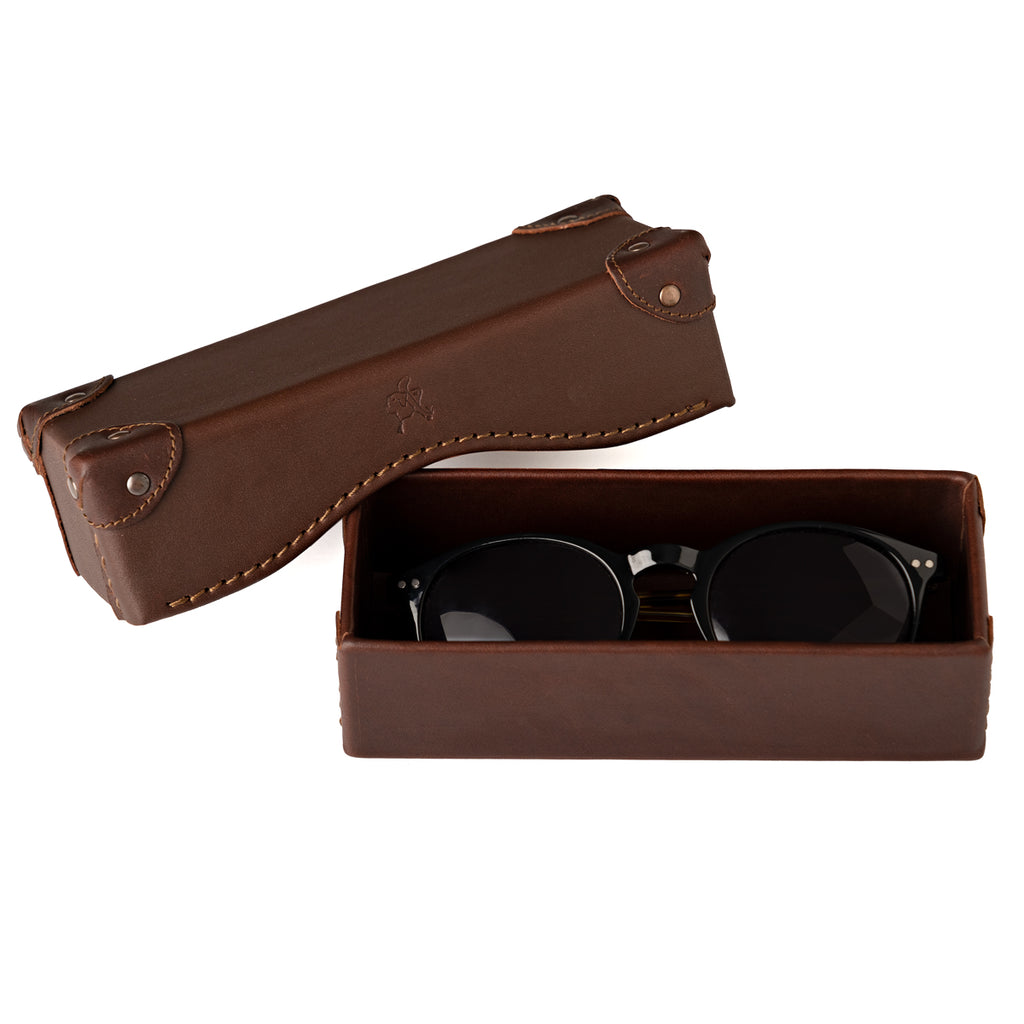 Grandfather Eyeglass Case in Chestnut leather, open with a pair of round sunglasses inside and lid beside it