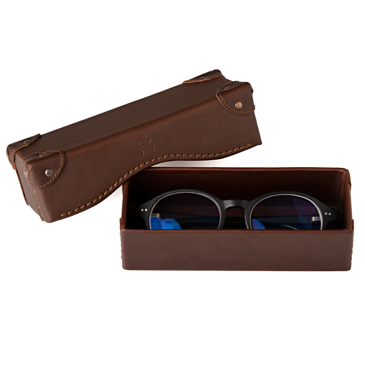 Grandfather Eyeglass Case in Chestnut leather, open with a pair of round eyeglasses inside and lid beside it