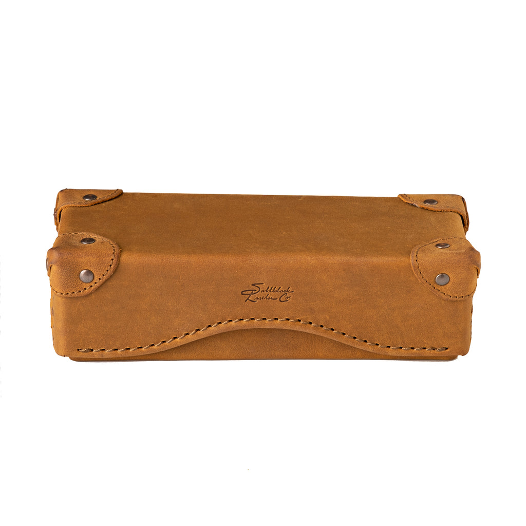 Grandfather Eyeglass Case in Tobacco leather, closed front view with riveted corner caps and embossed logo