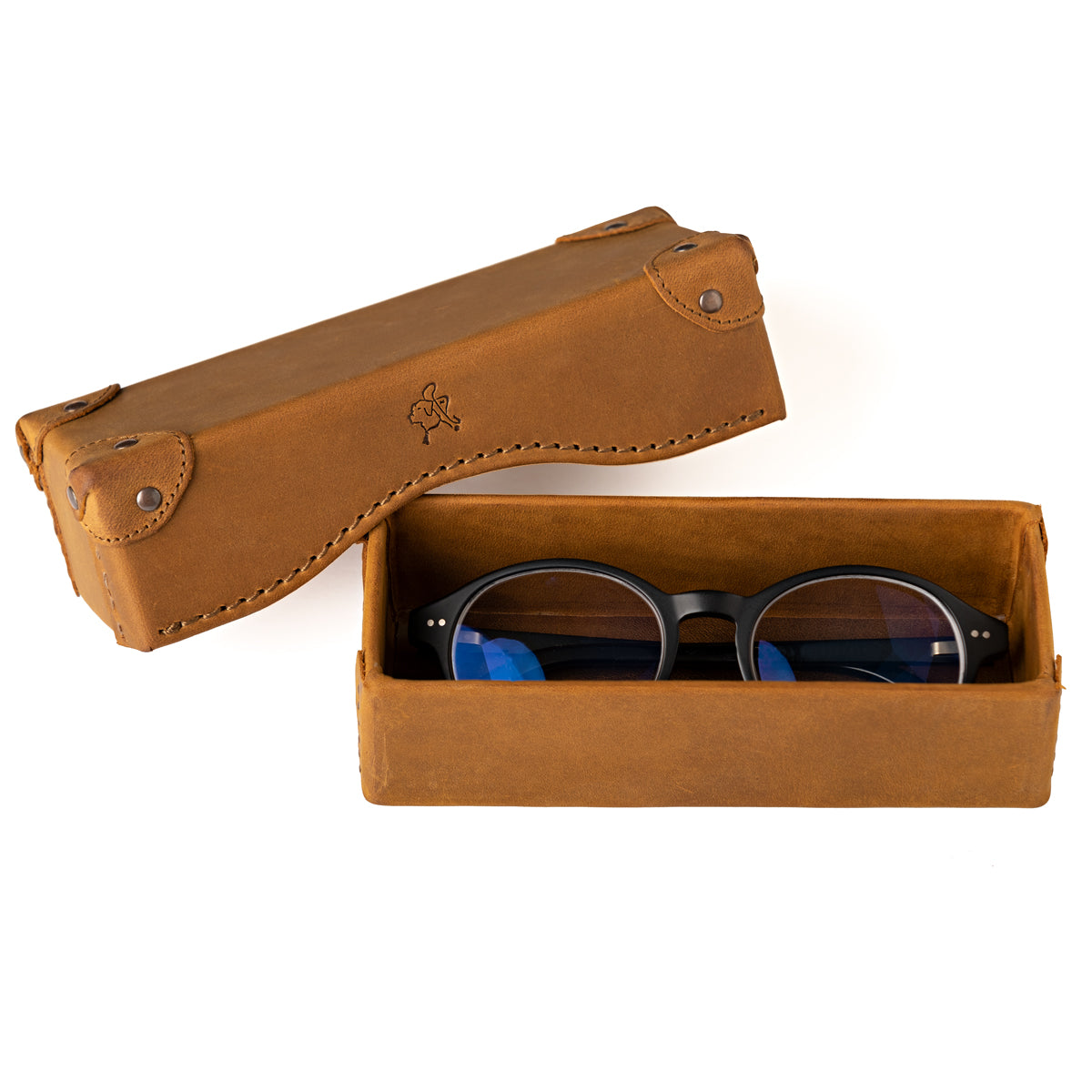Grandfather Eyeglass Case in Tobacco leather, open with a pair of round eyeglasses inside and lid beside it