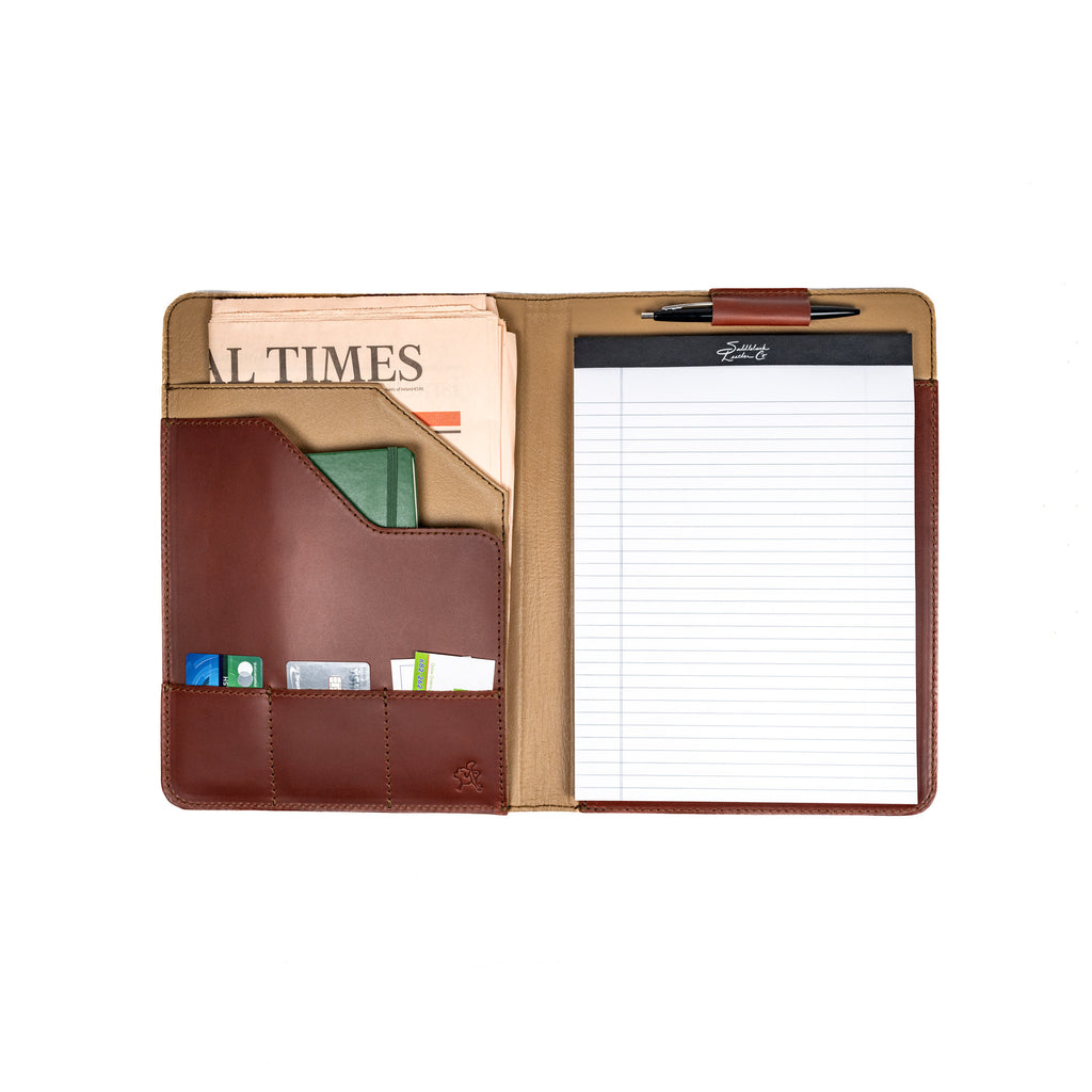 Old Design Medium Leather Portfolio in Chestnut, open with a legal pad, pen, newspaper and cards inside