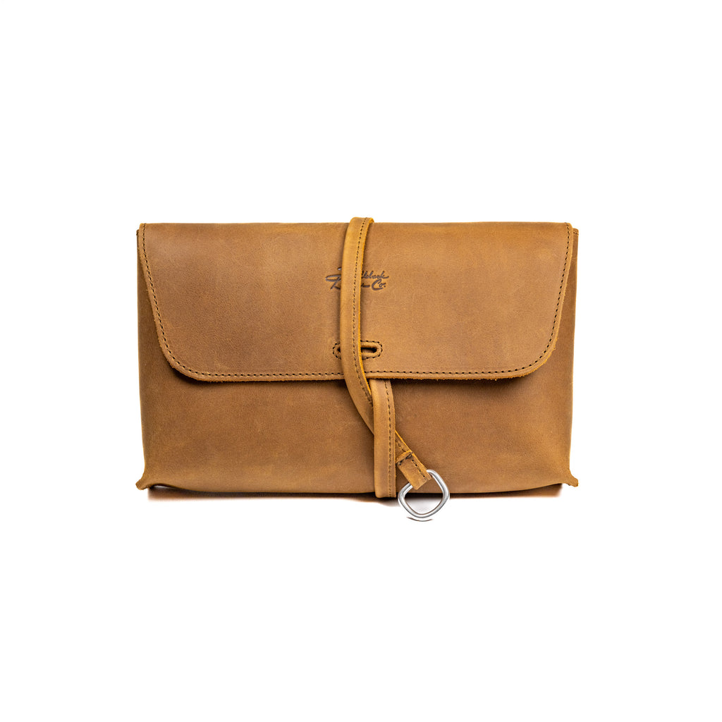 Large Leather Organizer Bag in Tobacco, closed flap with wrapped leather tie and ring, front view