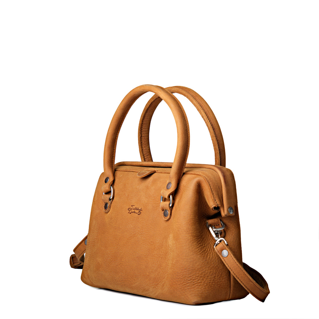 Everyday Purse in Tobacco, angled front view with rolled top handles, embossed logo and clipped shoulder strap