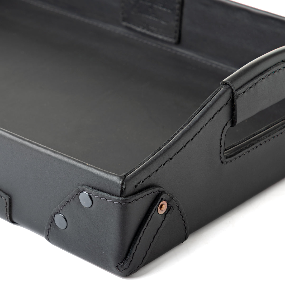 Grandfather Serving Tray in Black leather, close-up of riveted corner, stitching and handle