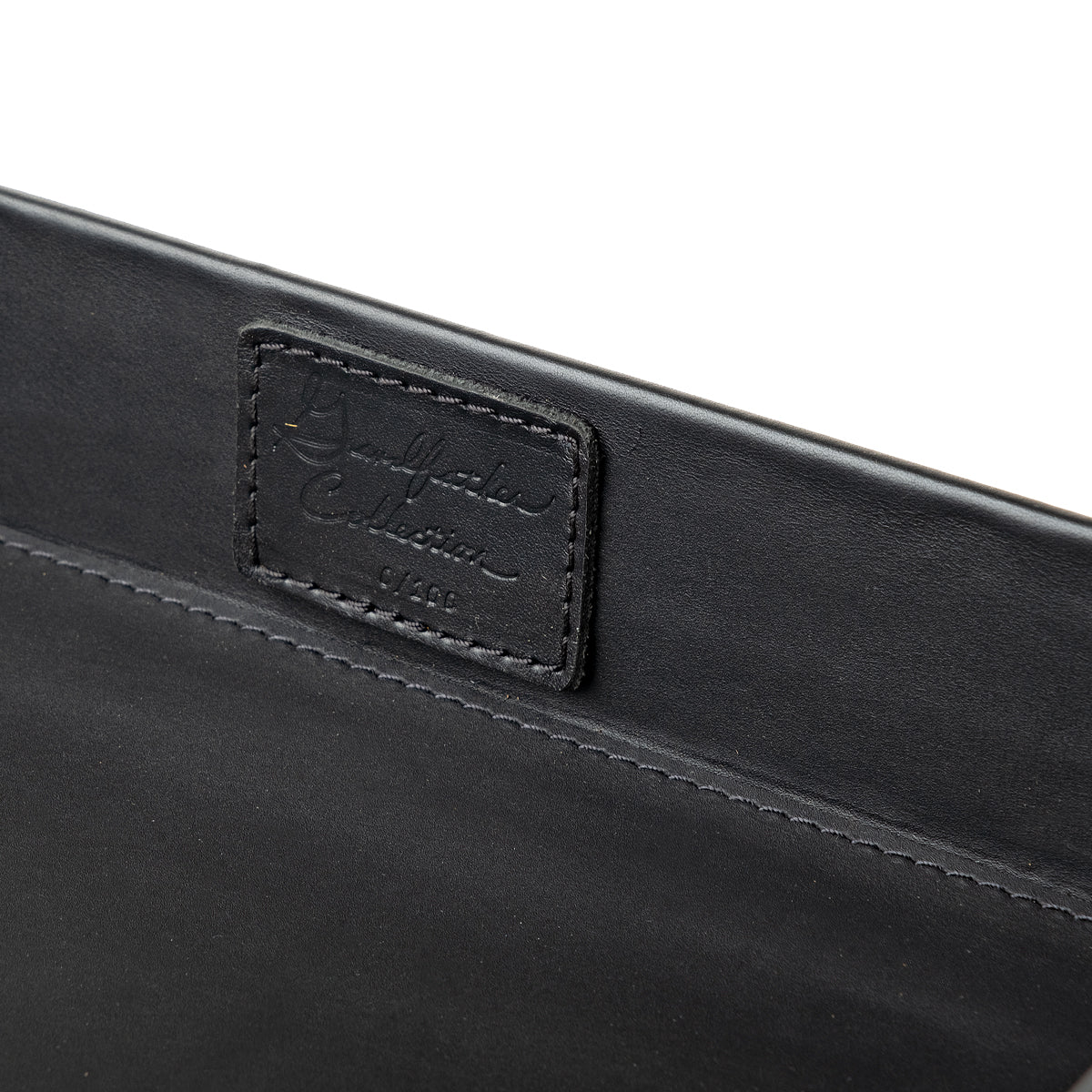 Grandfather Serving Tray in Black leather, close-up of stitched Grandfather Collection patch on the inner wall