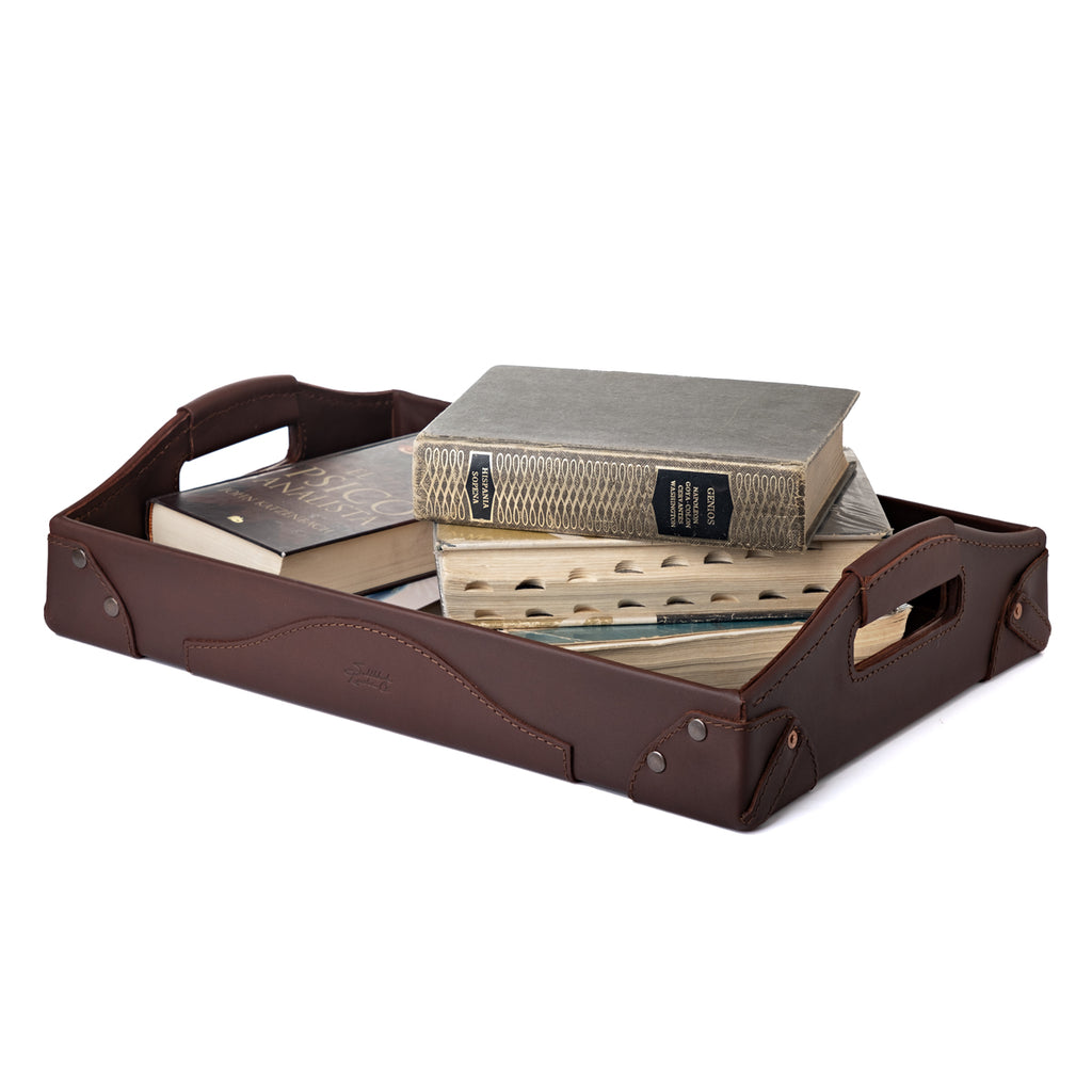Grandfather Serving Tray in Chestnut leather holding a stack of old hardcover books