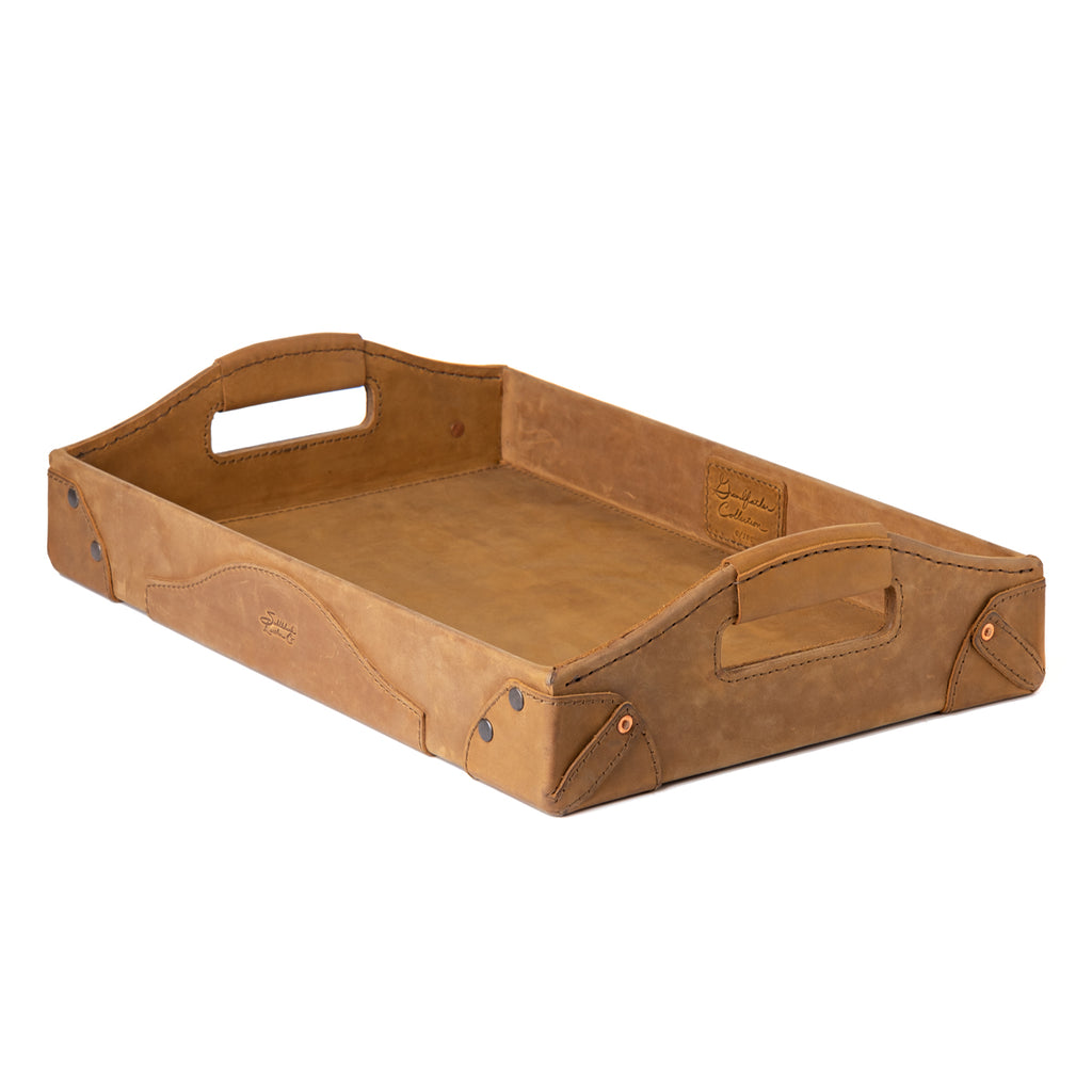 Grandfather Serving Tray in Tobacco leather, angled view with cut-out carry handles and riveted corners