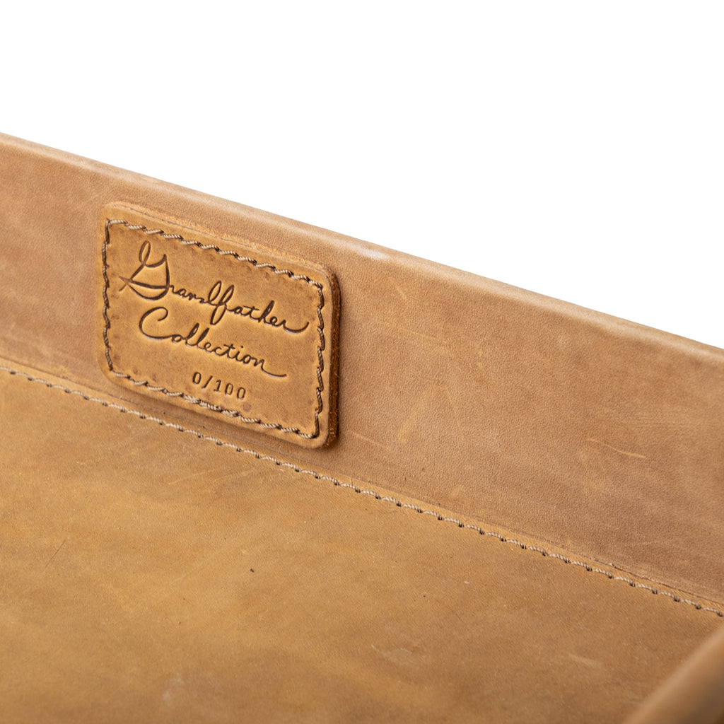 Grandfather Serving Tray in Tobacco leather, close-up of stitched Grandfather Collection patch on the inner wall