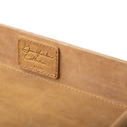 Grandfather Serving Tray in Tobacco leather, close-up of stitched Grandfather Collection patch on the inner wall