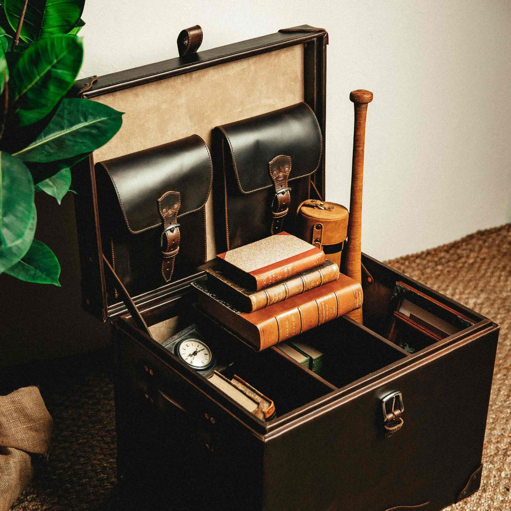 Leather Small Trunk in Dark Coffee Brown, open and filled with leather-bound books, a pocket watch and a baseball bat