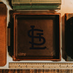 St. Louis Cardinals Leather Valet Tray in Dark Coffee Brown on a desk between old books and a wooden ruler
