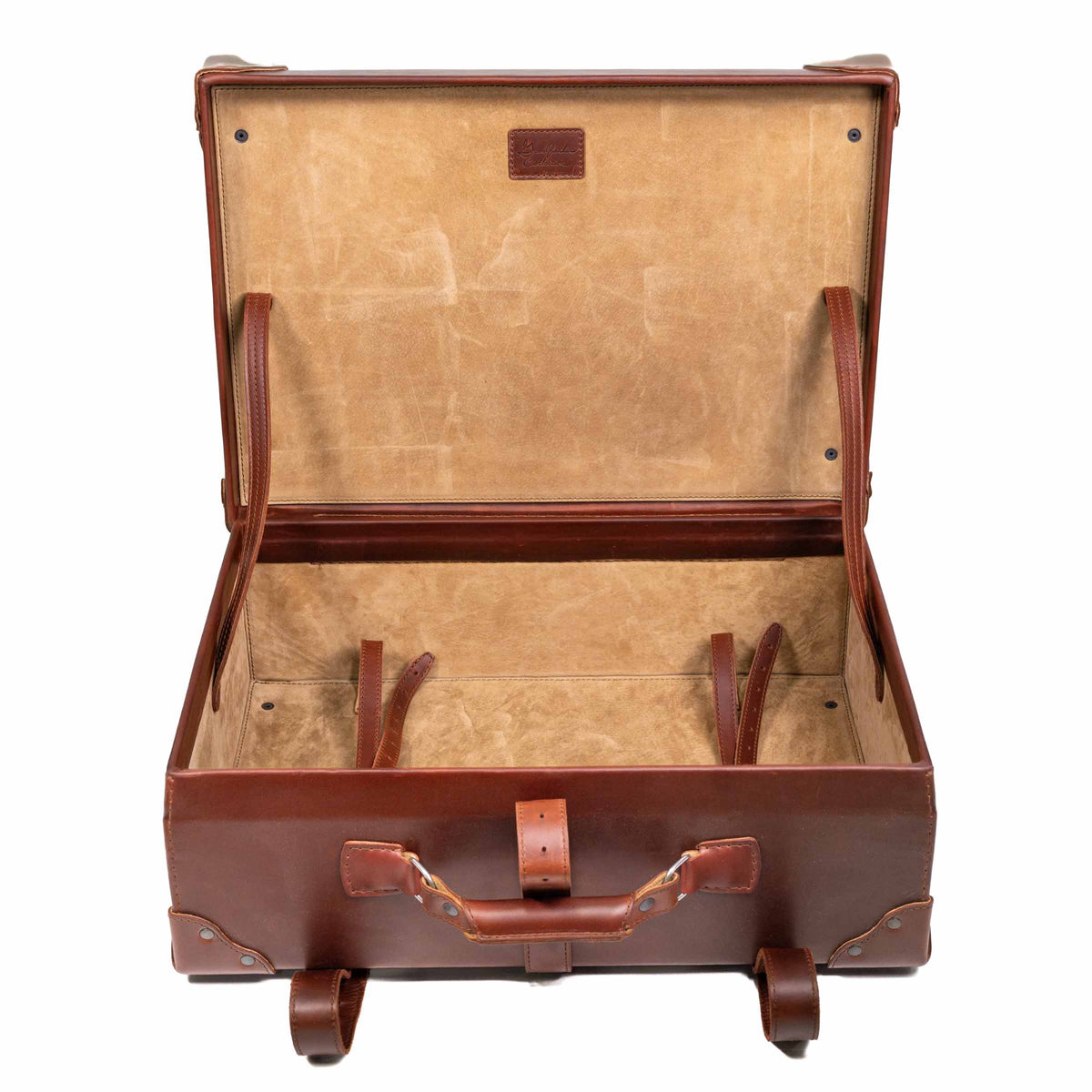 Grandfather Medium Suitcase in Chestnut, opened to show the canvas lining and leather tie-down straps