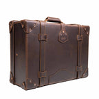 Grandfather Medium Suitcase in Dark Coffee Brown, angled back view with top handle, straps and riveted corners