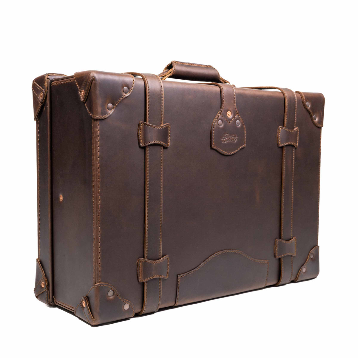 Grandfather Medium Suitcase in Dark Coffee Brown, angled back view with top handle, straps and riveted corners