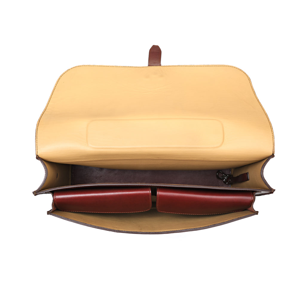 Livingstone Briefcase in Oxblood, top-down view with flap open showing the tan lining and inner pockets