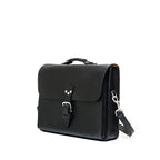 Livingstone Briefcase in Raven Black, angled side view showing the buckled flap and shoulder strap clip