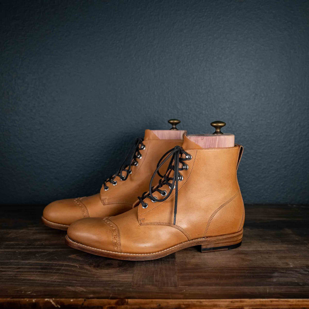 Officer's Boot in English Tan, side view of the pair with dark laces and cedar shoe trees