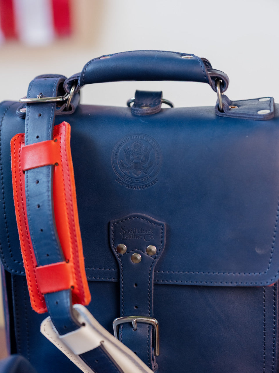 Saddleback Club Membership Paul Revere Leather Messenger Bag Backpack in Red, White and Blue, front flap with strap pad draped