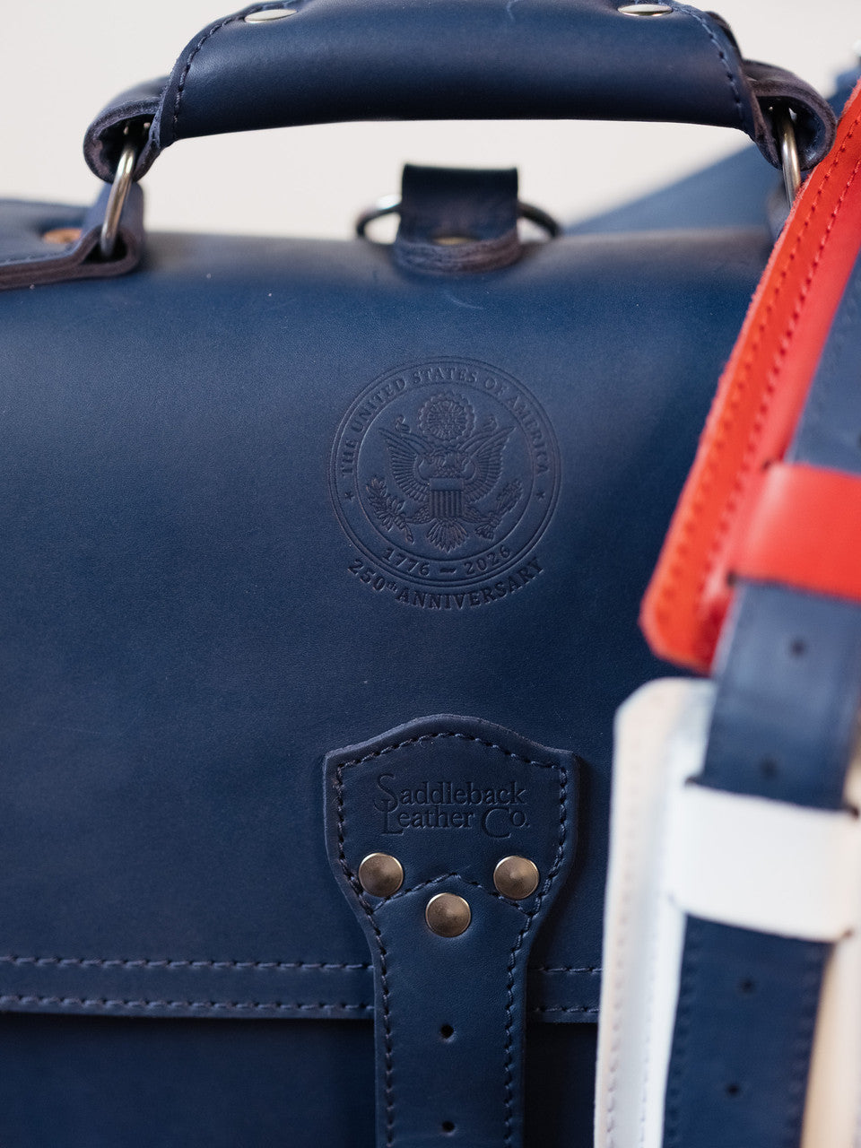 Saddleback Club Membership Paul Revere Leather Messenger Bag Backpack in Red, White and Blue, close-up of 250th anniversary seal