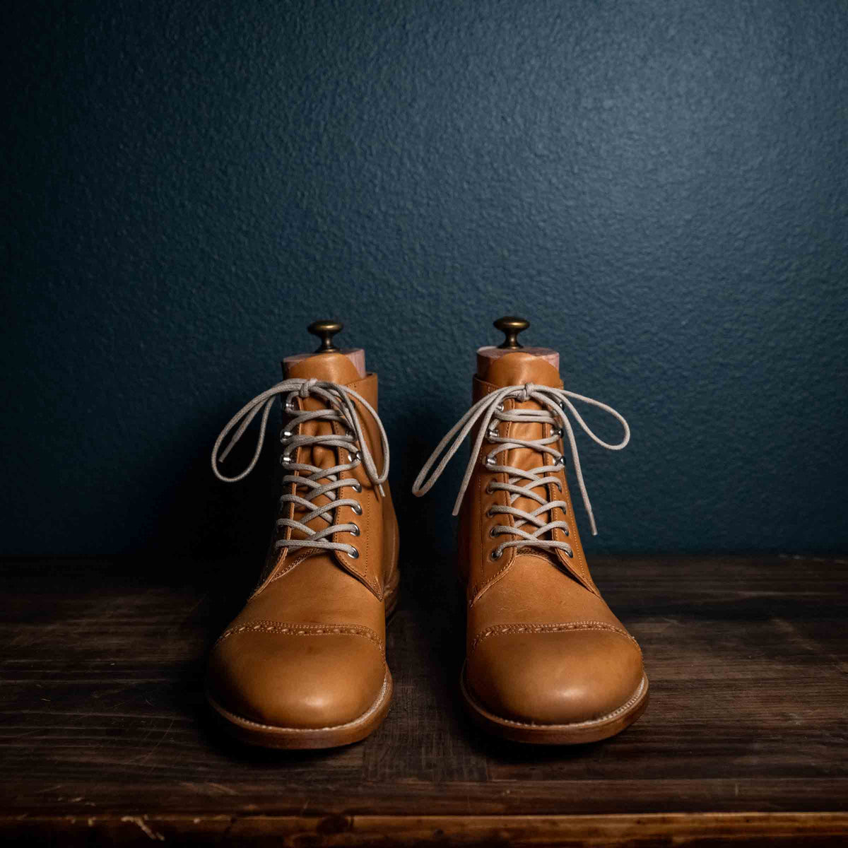 Officer's Boot in English Tan, front view of the pair with light laces and shoe trees