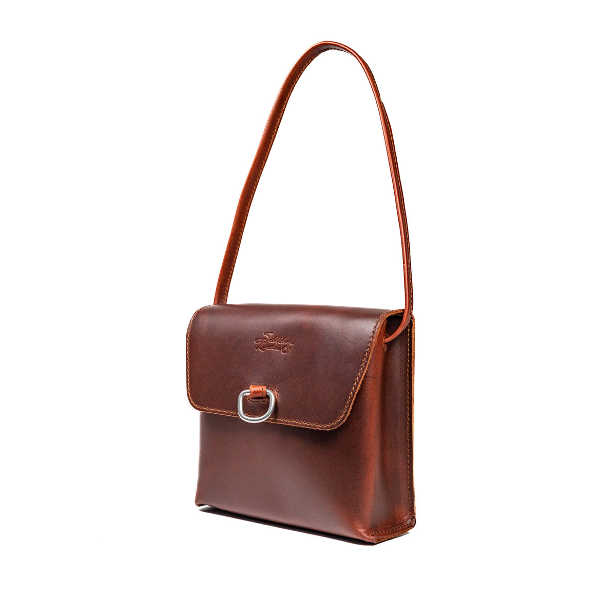 Leather Organizer Bag in Chestnut, angled view hanging from its strap with flap and metal ring closure