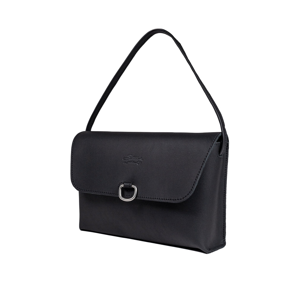 Large Leather Organizer Bag in Black, angled view with tie looped up as a carry handle and metal ring on the flap