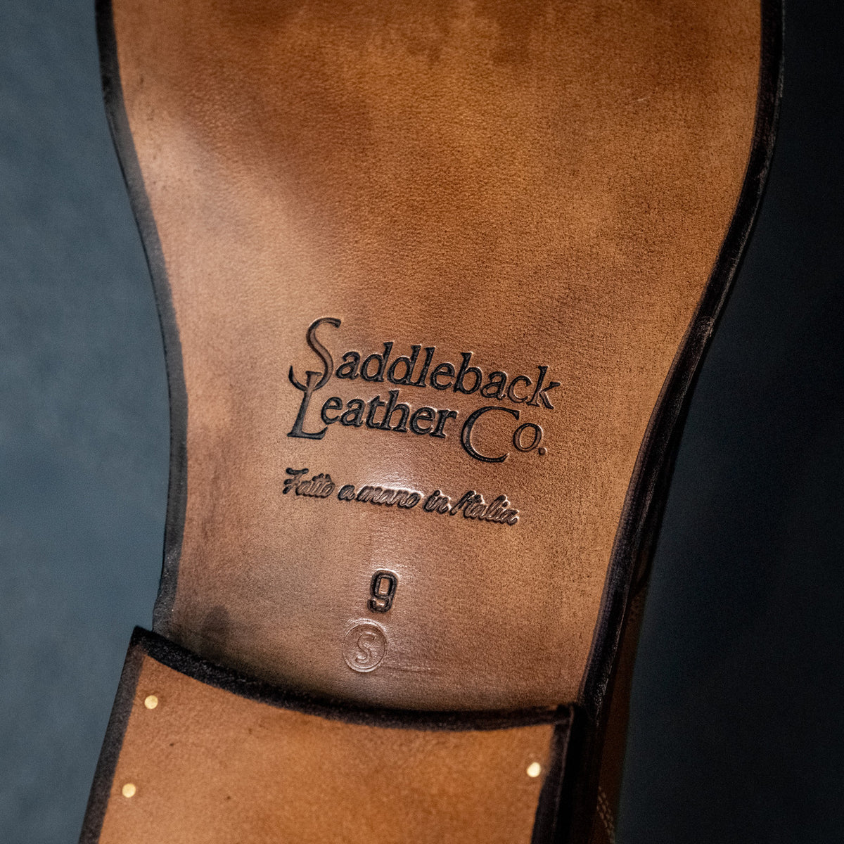 Leather sole of a high quality English tan leather Officer's Boot stamped Saddleback Leather Co., bottom view
