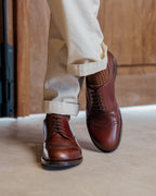 Toe Cap Shoes in Dark Oak, worn mid-stride with cuffed cream trousers