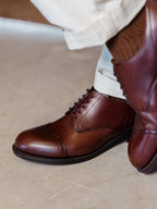 Toe Cap Shoes in Dark Oak, close-up of the cap toe and laces while worn with brown socks