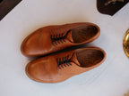 Toe Cap Shoes in English Tan, overhead view of the pair side by side on a white surface