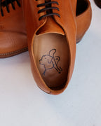 Toe Cap Shoes in English Tan, close-up of the leather insole with the dog logo