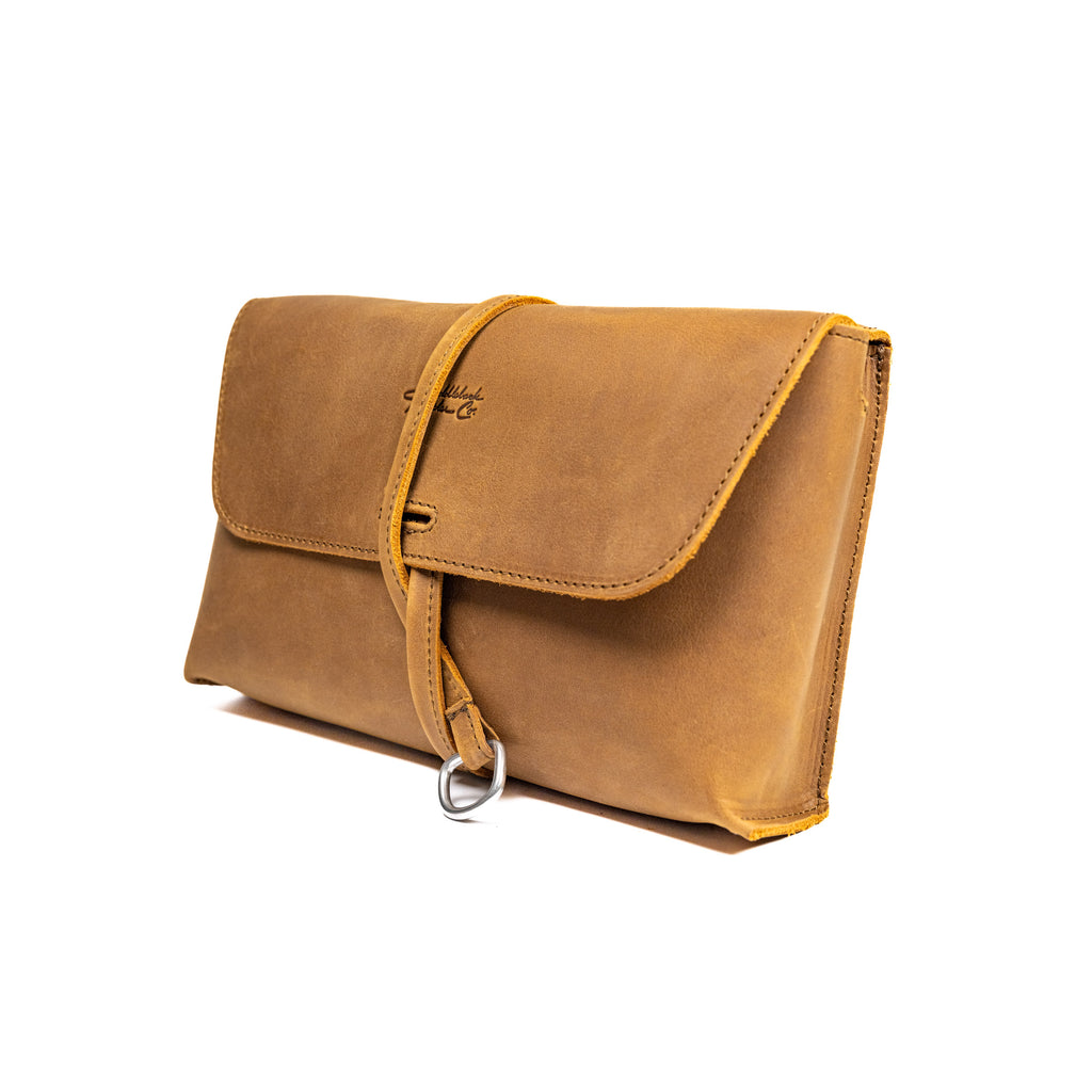 Large Leather Organizer Bag in Tobacco, closed flap with wrapped leather tie and ring, angled view