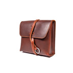 Leather Organizer Bag in Chestnut, three-quarter view with flap closure and strap wrapped around the front