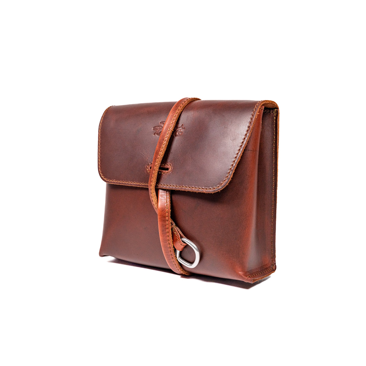 Leather Organizer Bag in Chestnut, three-quarter view with flap closure and strap wrapped around the front