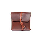 Leather Organizer Bag in Chestnut, straight-on front view with flap closure and strap looped through a metal ring