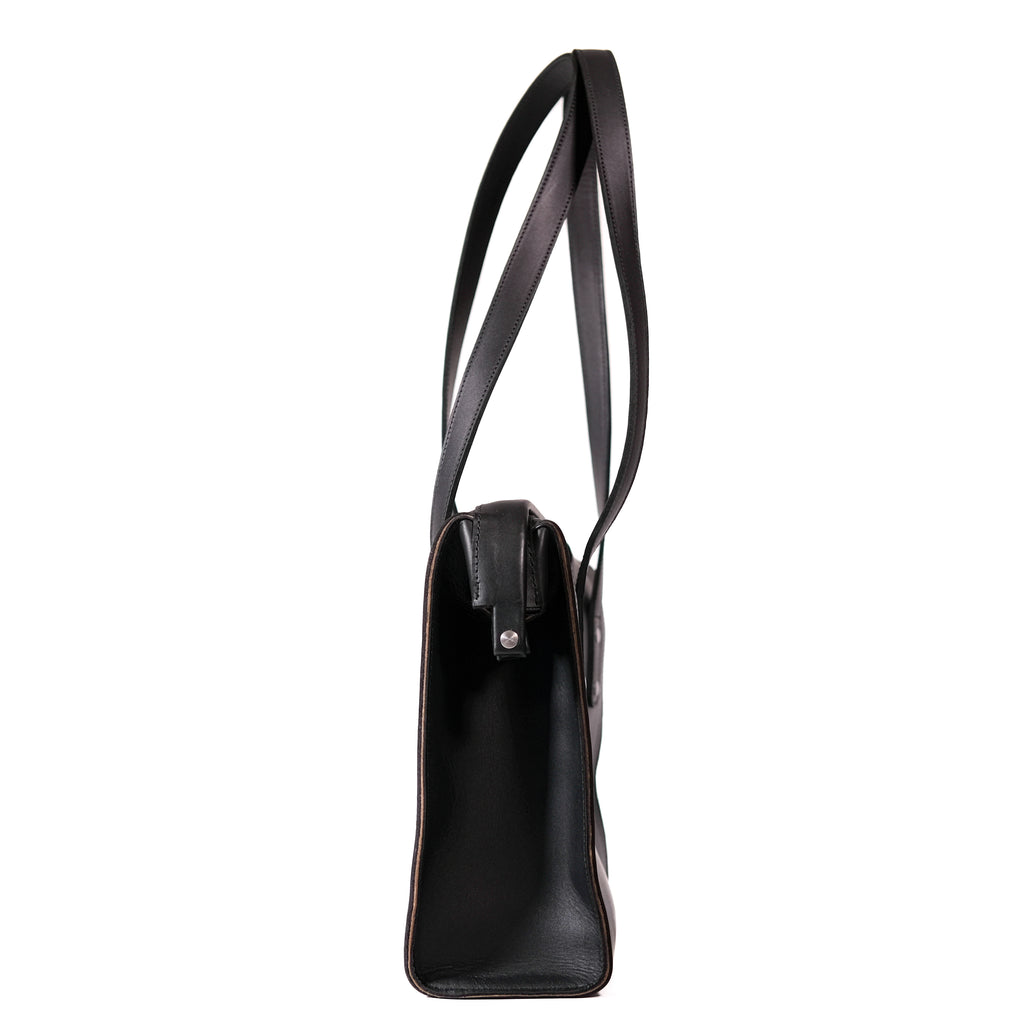 Professional Leather Tote in Black, side profile view showing the slim gusset and shoulder handles