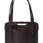Professional Leather Tote in Dark Coffee Brown, close-up of the cutout grip, handles and a phone in the front pocket