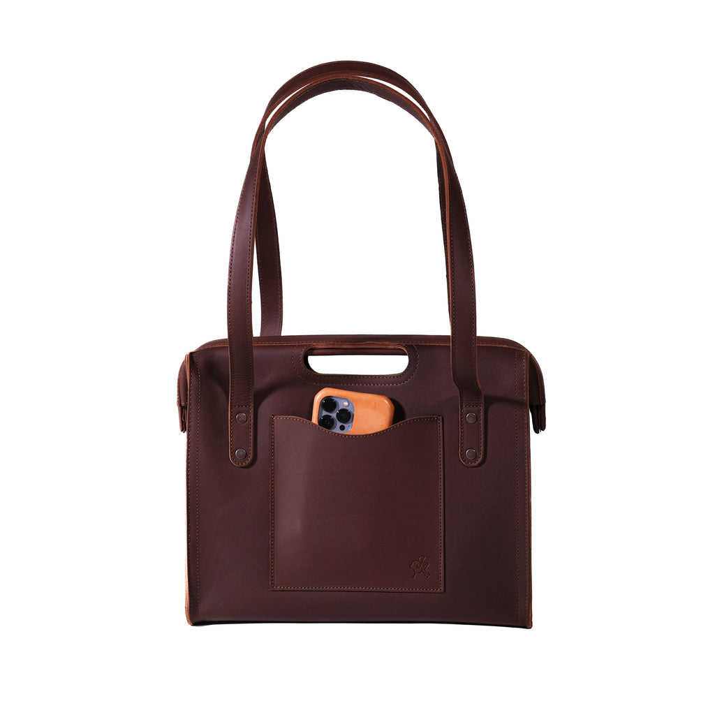 Professional Leather Tote in Chestnut, front view with shoulder handles, cutout grip and a phone in the front pocket