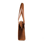 Professional Leather Tote in Tobacco, side profile view showing the slim gusset and shoulder handles