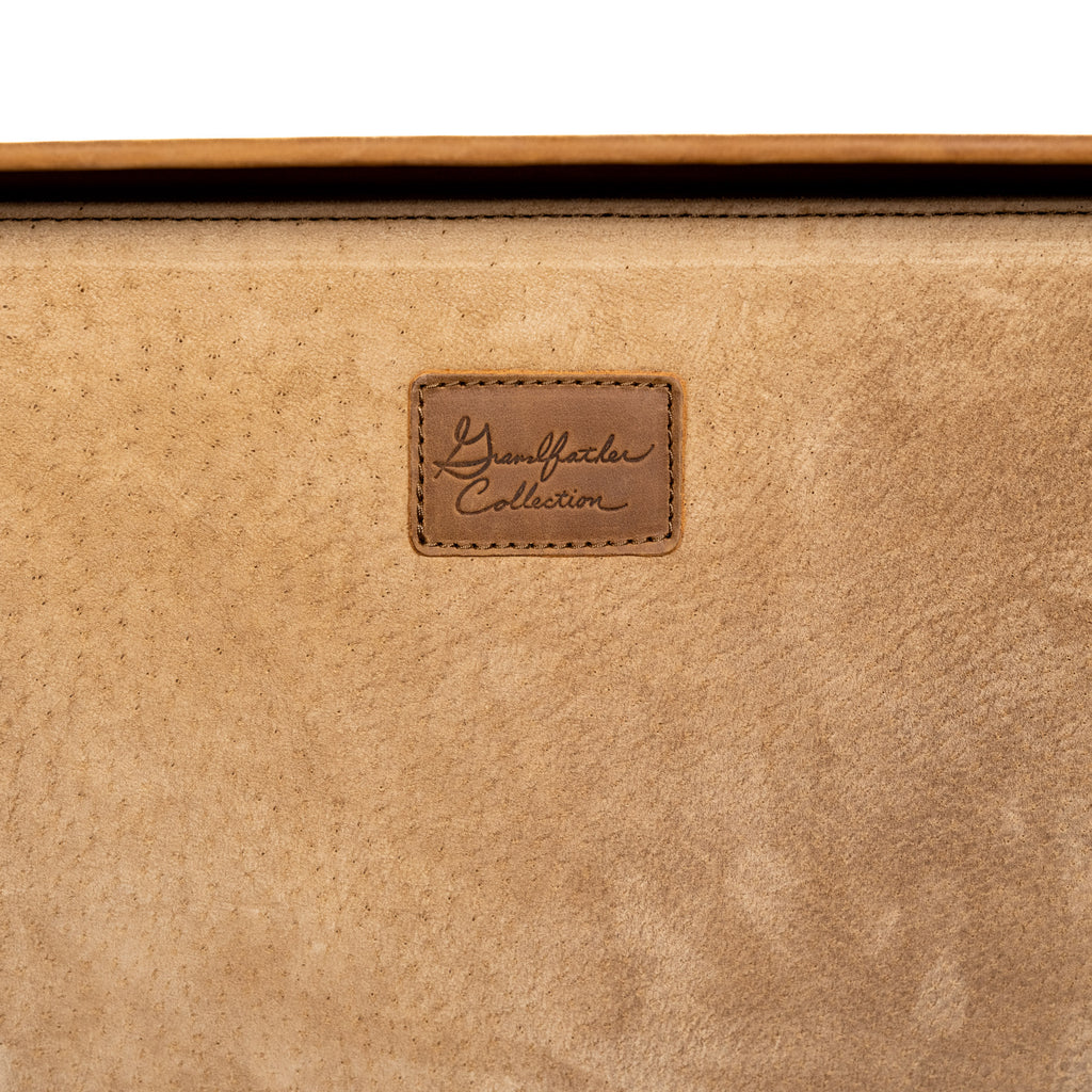 Grandfather Suitcase in Tobacco, close-up of the embossed Grandfather Collection leather patch on the lining