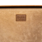 Grandfather Suitcase in Tobacco, close-up of the embossed Grandfather Collection leather patch on the lining