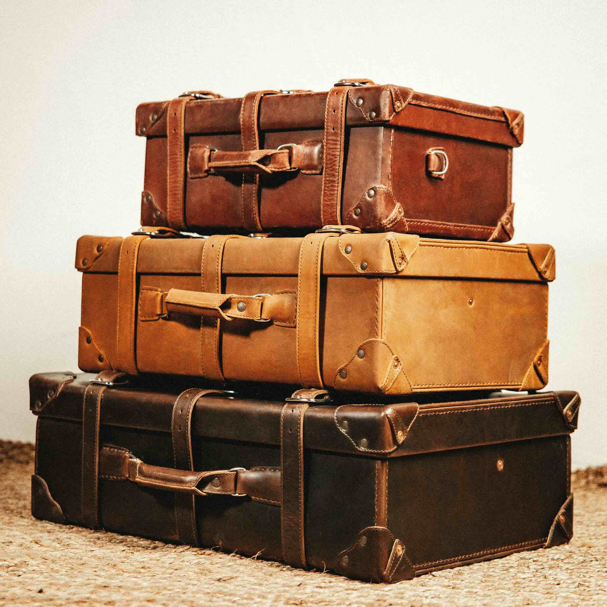 Grandfather Medium Suitcase stacked with Grandfather luggage in Chestnut, Tobacco and Dark Coffee Brown