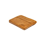 Front Pocket Leather ID Wallet in Tobacco lying at an angle to show its thin profile and natural edge